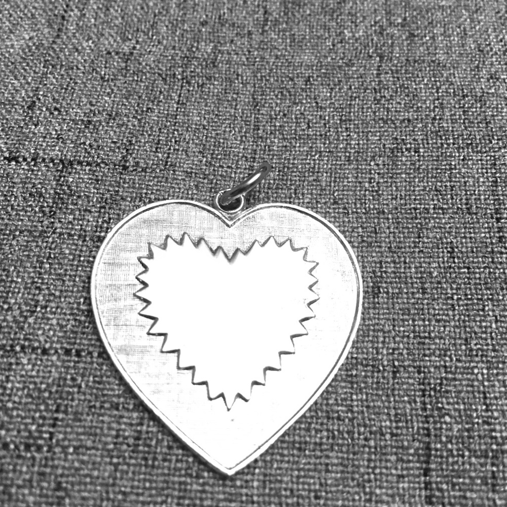 silver colored heart pendant